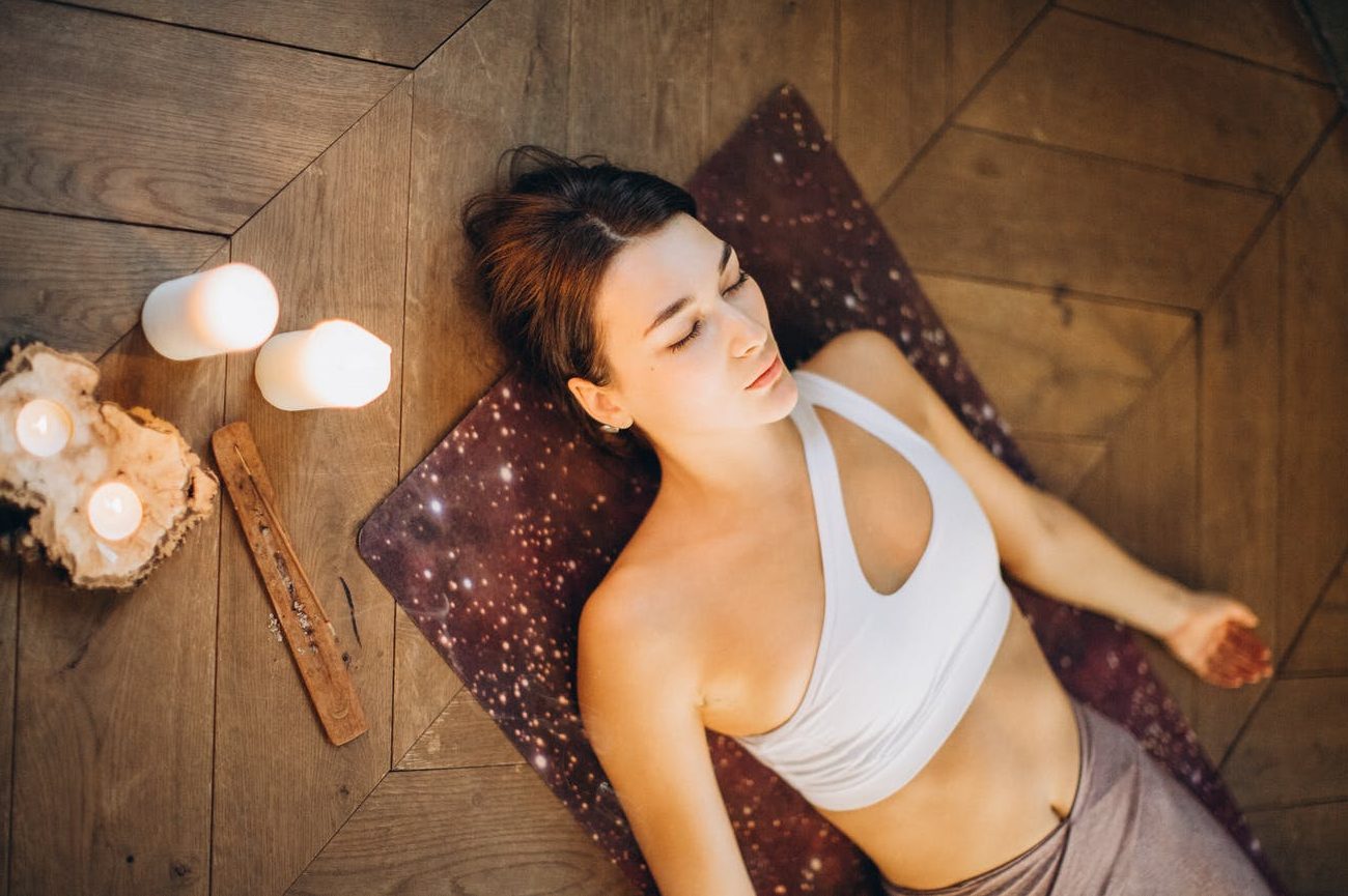 woman relaxing in yoga mat